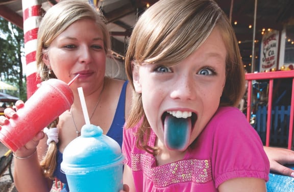 kid-sticking-out-tongue-holding-frozen-beverage-reverse@2x