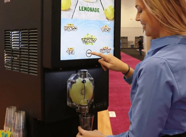 woman-using-lemonade-dispenser@2x