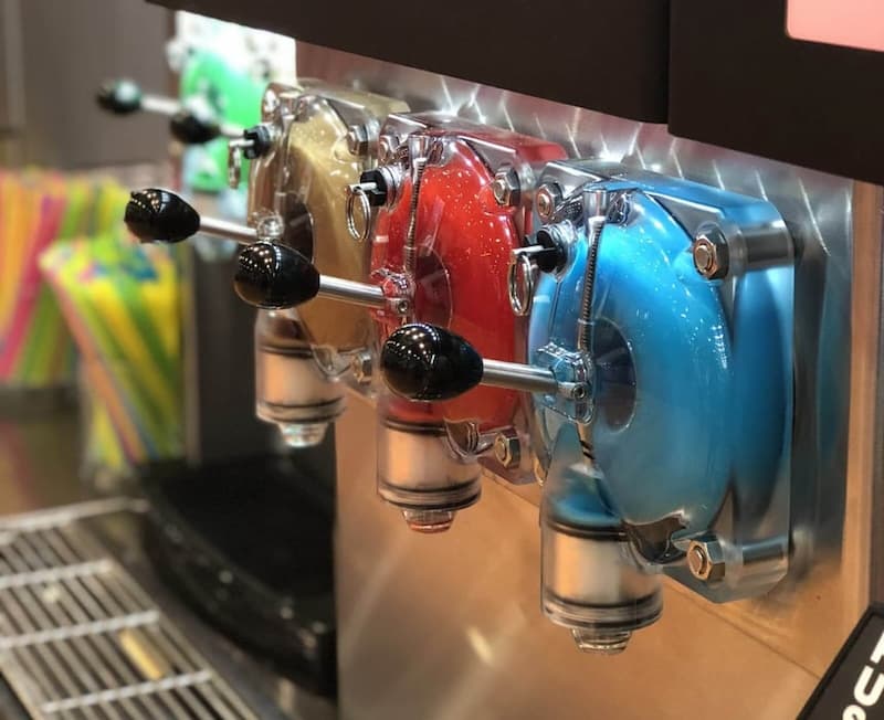 FBD Frozen. Frozen drink dispensers with brown, red, and blue flavors.