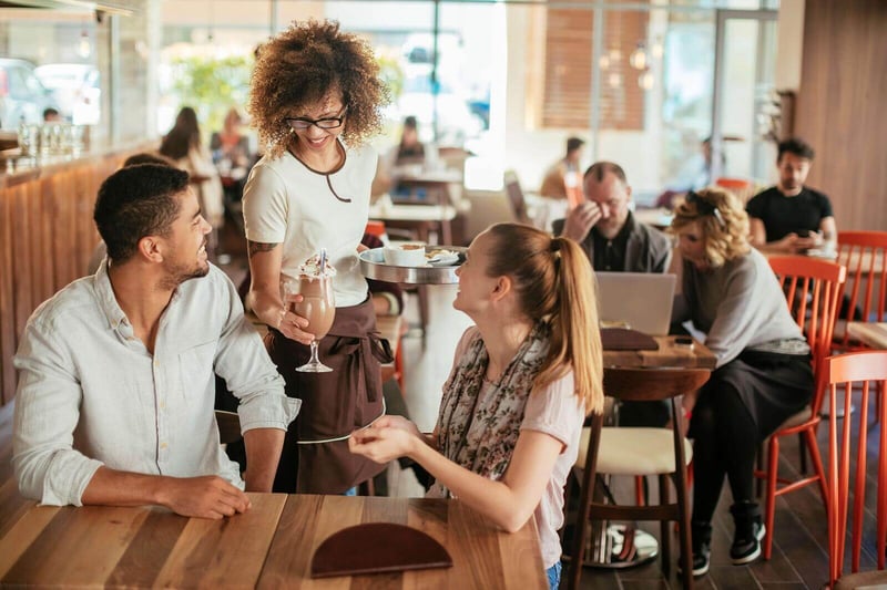 FBD Frozen. Waitress gives a patron a nitro-infused frozen beverage.