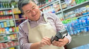 man smiling while doing inventory