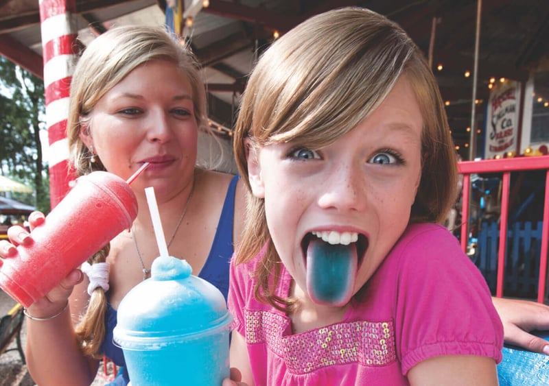 FBD Frozen. Child enjoys frozen beverage at amusement park.