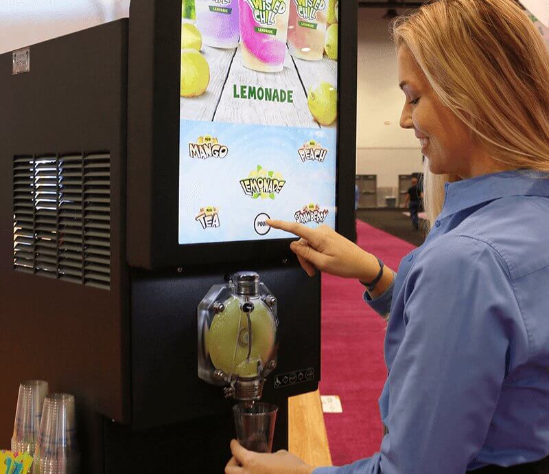 FBD Frozen. Woman using multi-flavor frozen drink machine.