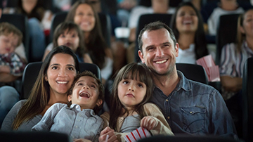 family of 4 at a movie theater
